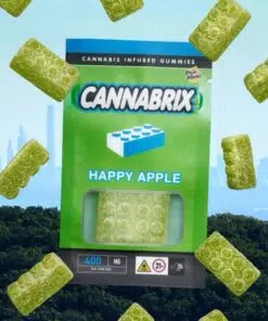 Green cannabis-infused gummies, Cannabrix Happy Apple flavor, displayed with New York City skyline in the background.