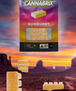 Alt text: Cannabrix Sunburst cannabis-infused gummy packaging with colorful background and floating gummies.