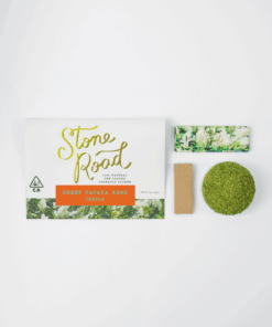 Stone Road Sweet Papaya Kush Indica cannabis package with pre-ground flower and rolling papers on white background.
