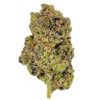 Close-up of a frosty cannabis bud with green and purple hues, showcasing its trichomes and dense structure.