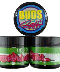 Cannabis jars labeled Watermelon Fuel and Buds and Such, with colorful branding.