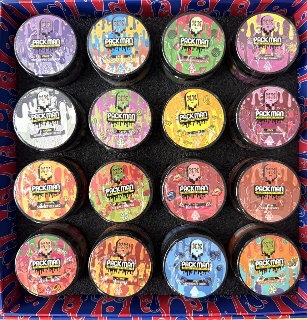 Colorful array of Pack Man cannabis concentrates in a stylish box, showcasing various enticing flavors and designs.