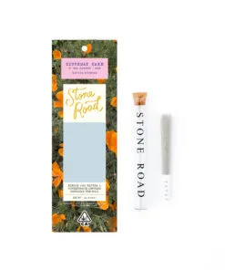 Alt text: Stone Road Birthday Cake cannabis pre-roll packaging with a pre-roll and glass tube, featuring floral design.