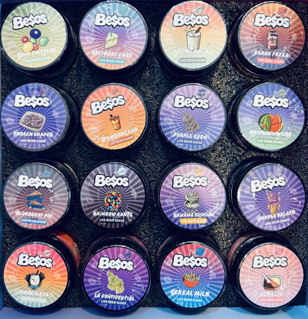 Variety of Besos live resin sugar containers in vibrant flavors like Birthday Cake, Mango, and Purple Kush.