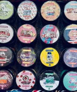 Colorful collection of Backpackboyz cannabis products, featuring live resin sugar jars with unique flavors and designs.
