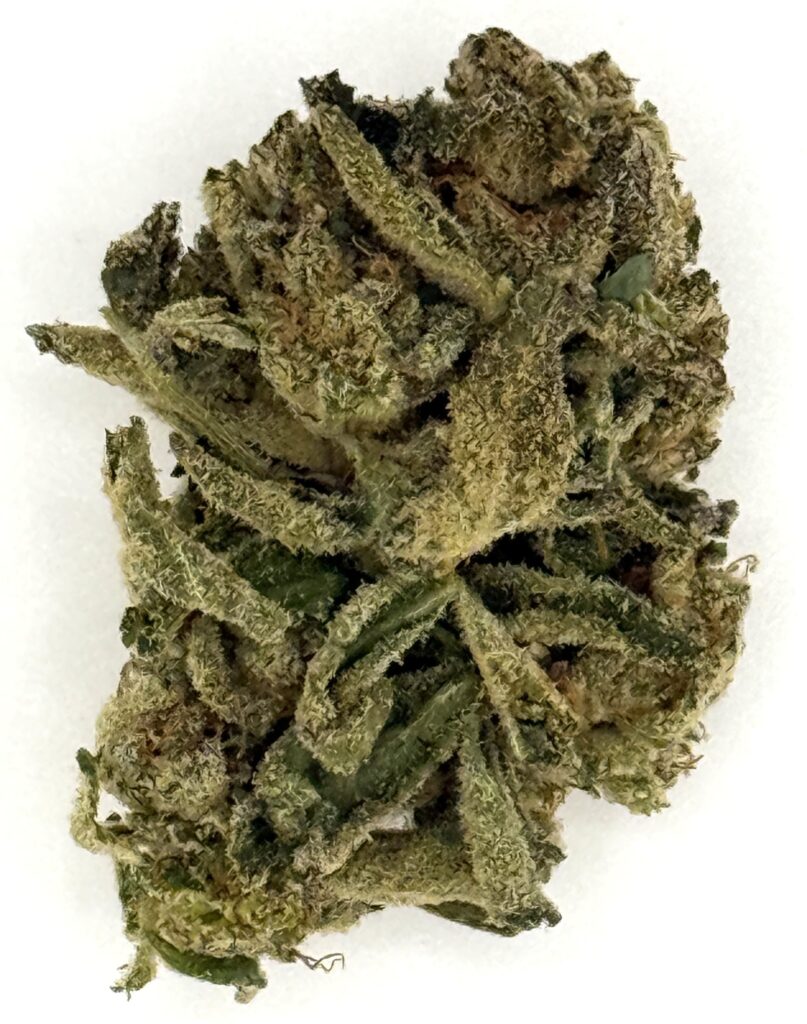 Image of a close-up view of cannabis buds with fine trichomes and green leaves, highlighting its rich texture and quality.
