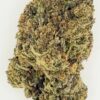Close-up of a dried cannabis bud, showcasing its dense structure and rich green and brown hues, ideal for herbal use.