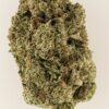 Close-up of a cannabis bud showcasing rich green hues and fine trichomes, highlighting its quality and texture.