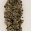 Close-up of a dense cannabis bud showcasing trichomes and earthy colors, highlighting its rich texture and quality.