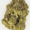 Close-up of dense, green cannabis flower showcasing its rich trichomes and natural texture on a white background.