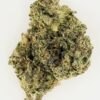 Close-up of a cannabis bud showcasing its dense, frosty trichomes and vibrant green hues on a white background.