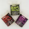 Three containers of Heavy Melts moon rocks featuring premium cannabis, badder, and kief in vibrant packaging.