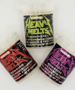 Three containers of Heavy Melts moon rocks featuring premium cannabis, badder, and kief in vibrant packaging.