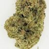 Close-up of a cannabis bud showcasing its green color and fine trichomes on a white background.