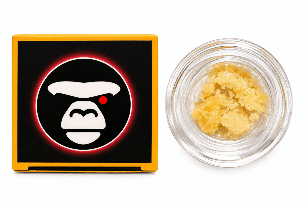 Close-up of a cannabis concentrate jar beside branded packaging featuring a stylized gorilla logo.